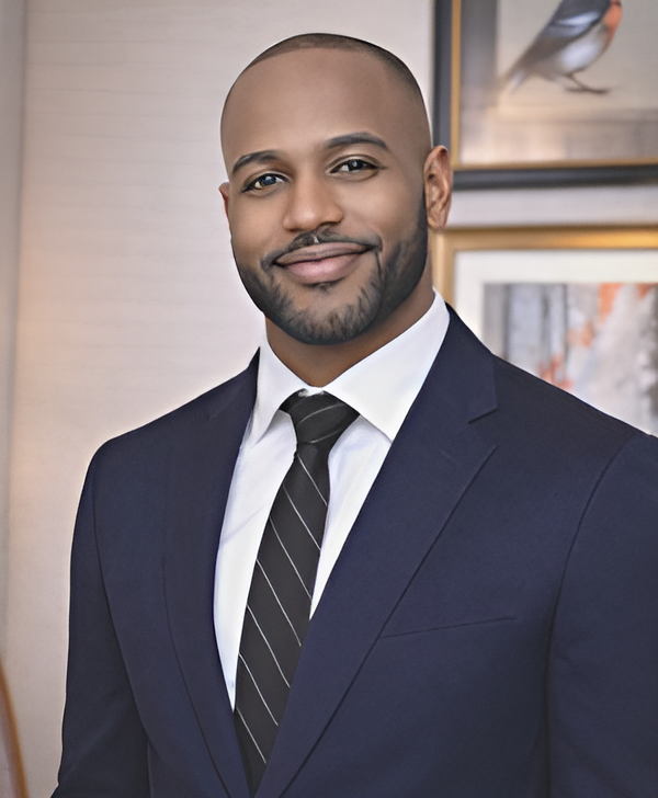 Phillip Coleman, Chief Financial Officer of Mindbodysoul Psychiatry — professional portrait in dark suit with warm modern interior background