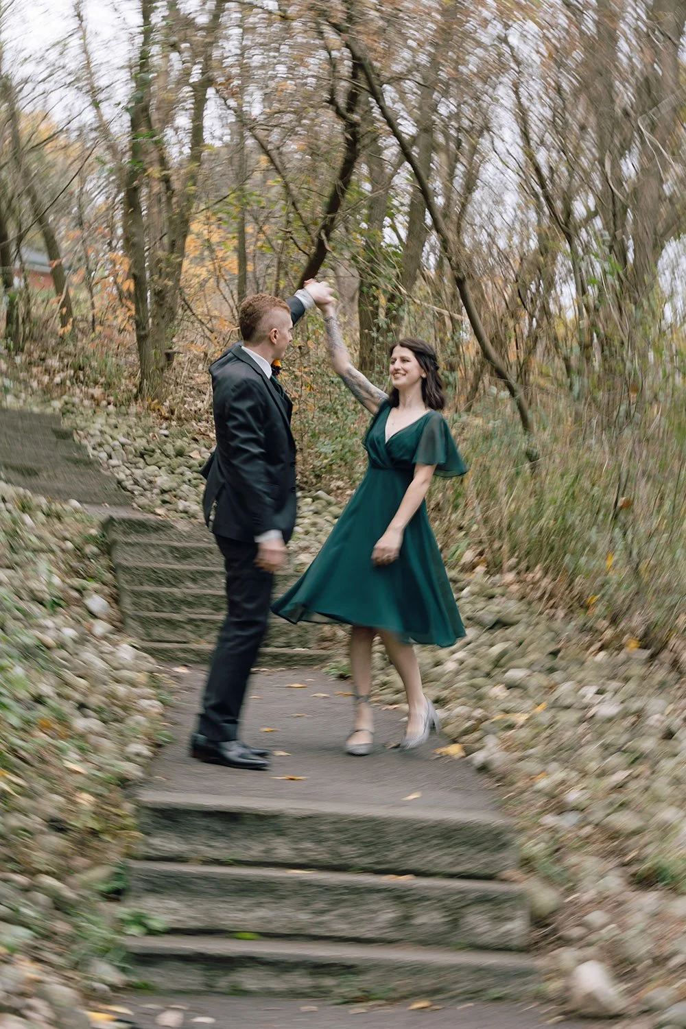 Bride and groom candidly dancing together during their wedding portraits in Ontario, captured by a documentary-style wedding photographer.