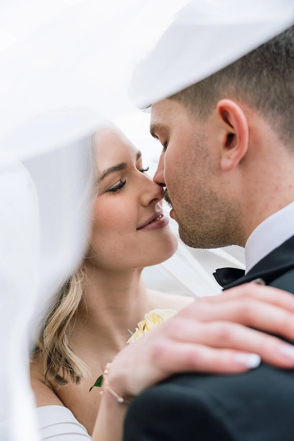 Bride and groom posing together under a veil during documentary-style Ontario wedding photography