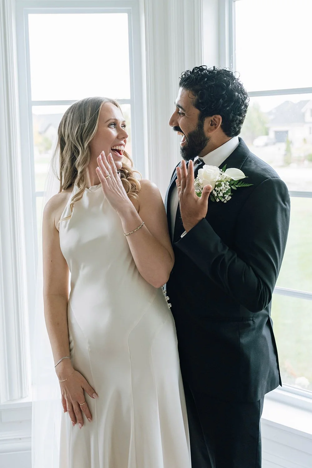 Newlywed couple showing off their wedding rings during documentary-style Hamilton wedding photography