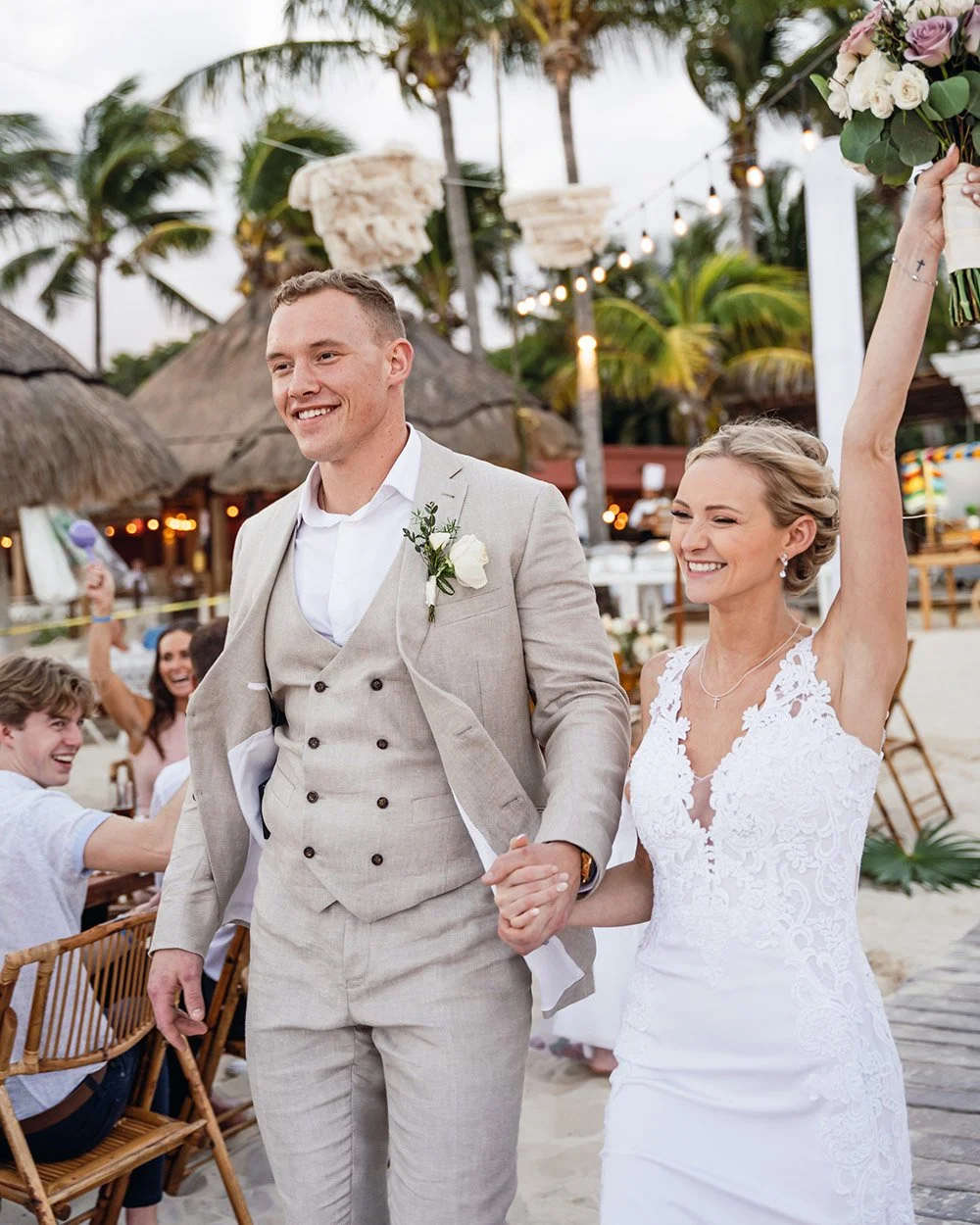 Bride and groom making a joyful reception entrance at a destination wedding in Mexico