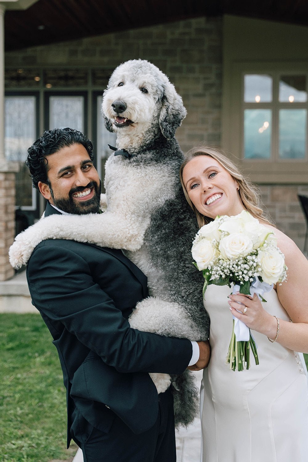 Couple posing with their dog after an intimate Ontario wedding ceremony