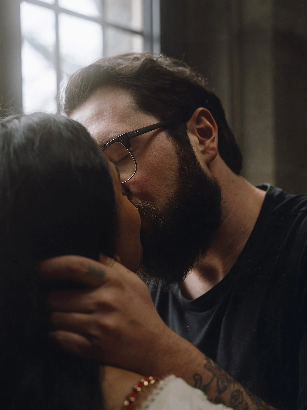 An engaged couple shares a romantic kiss on campus in Hamilton, Ontario
