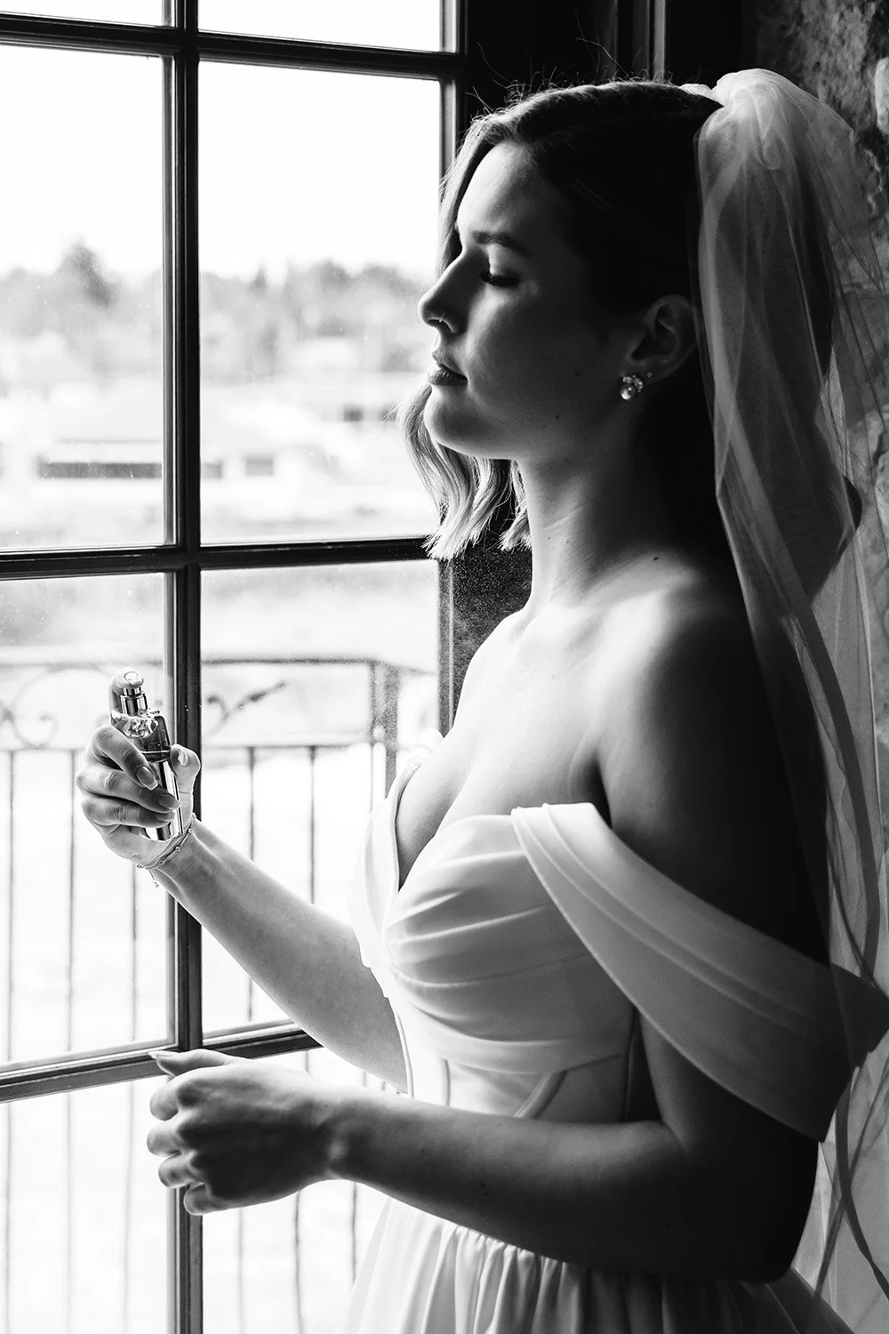 Bride spraying perfume while getting ready for her wedding in Ontario
