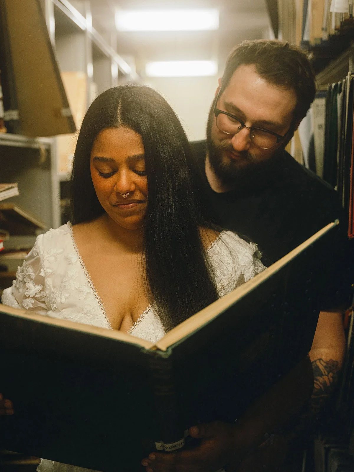 An engaged couple reads a book in a university library in Hamilton, Ontario