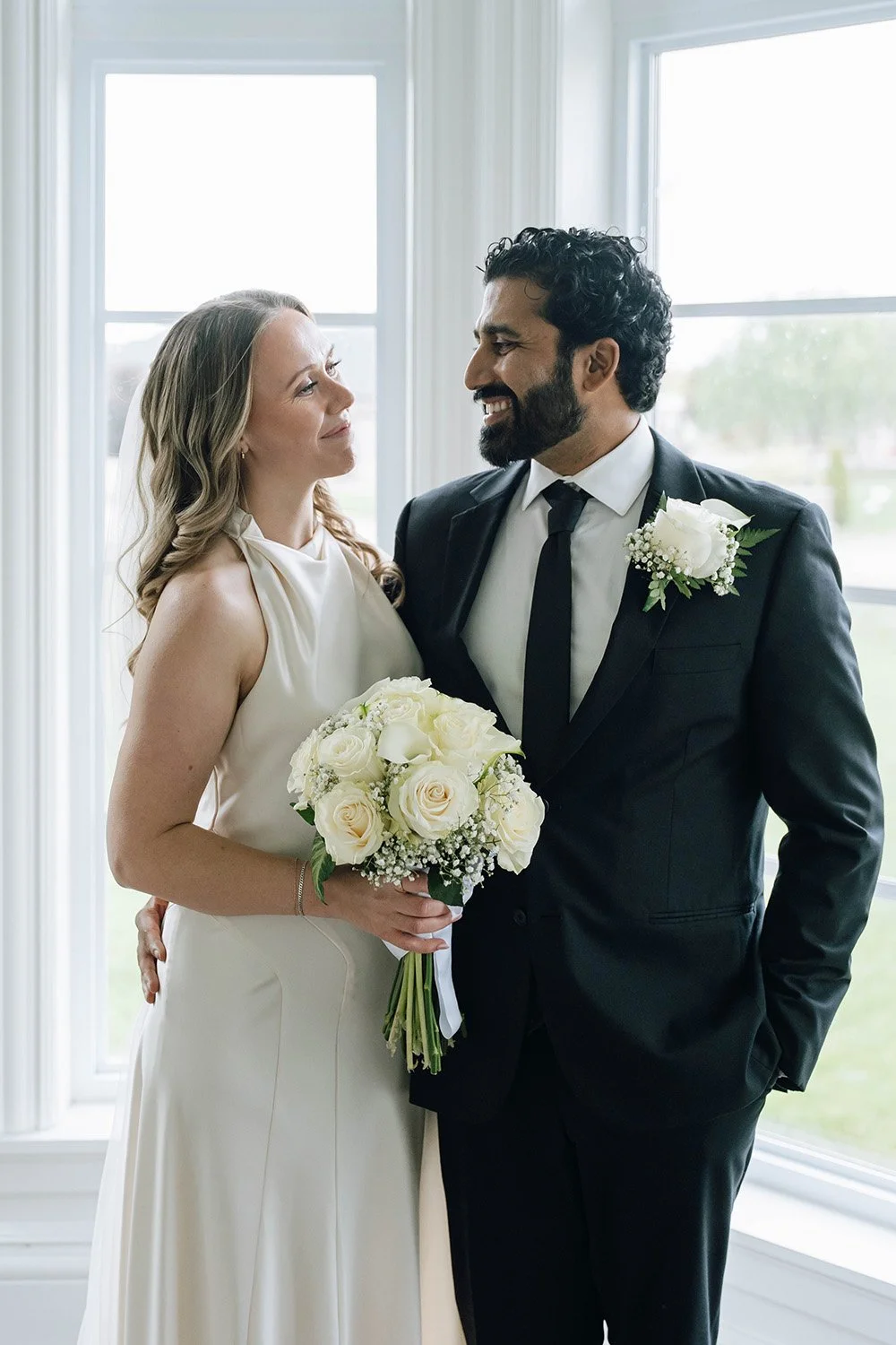 Couple smiling at each other during a natural Ontario wedding portrait session