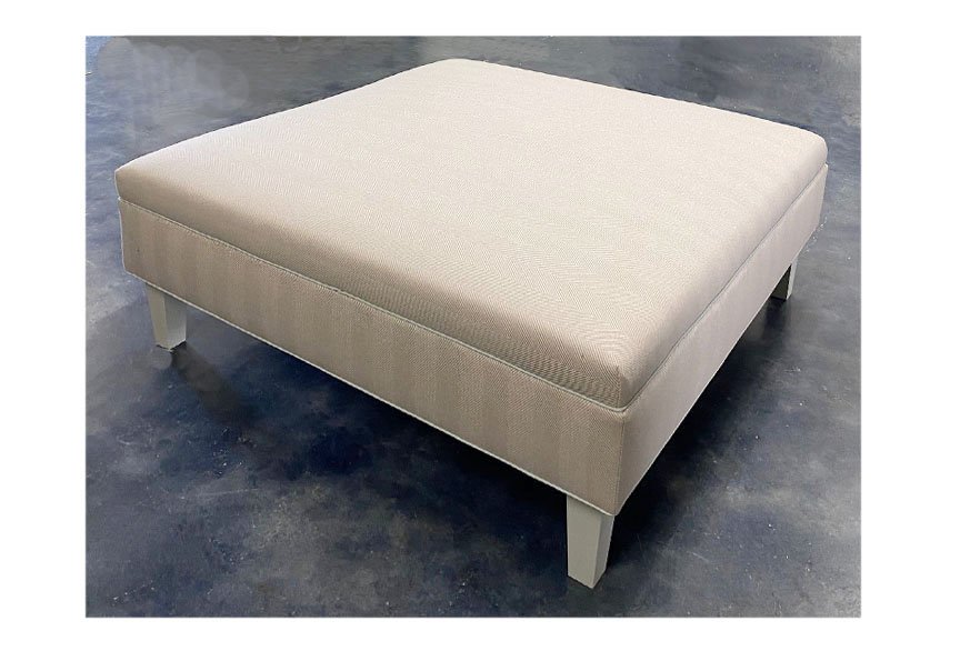 ottoman with piping tapered legs.jpg