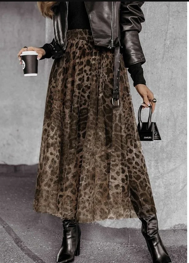 Woman wearing a leopard print skirt and black boots