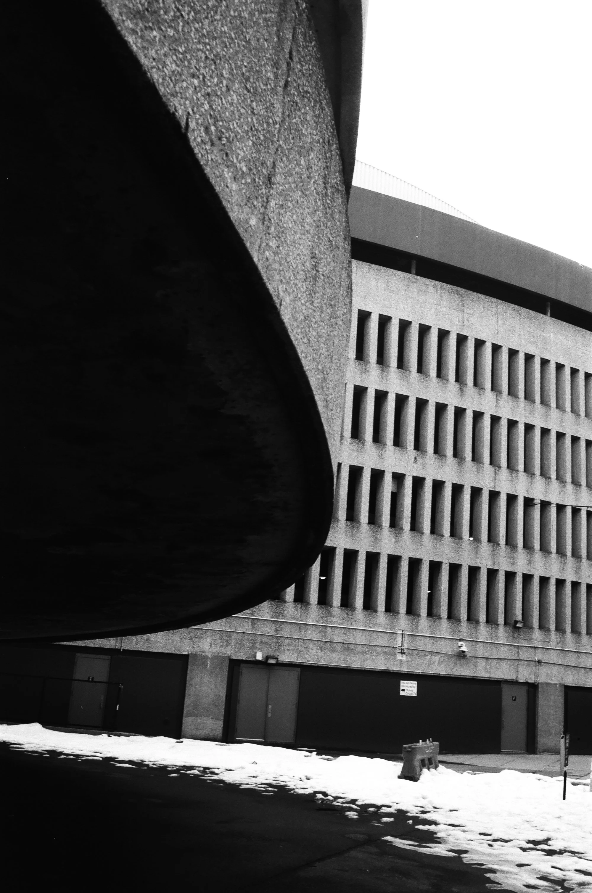   the contrast between the main shopping core and the mall’s parking garage  