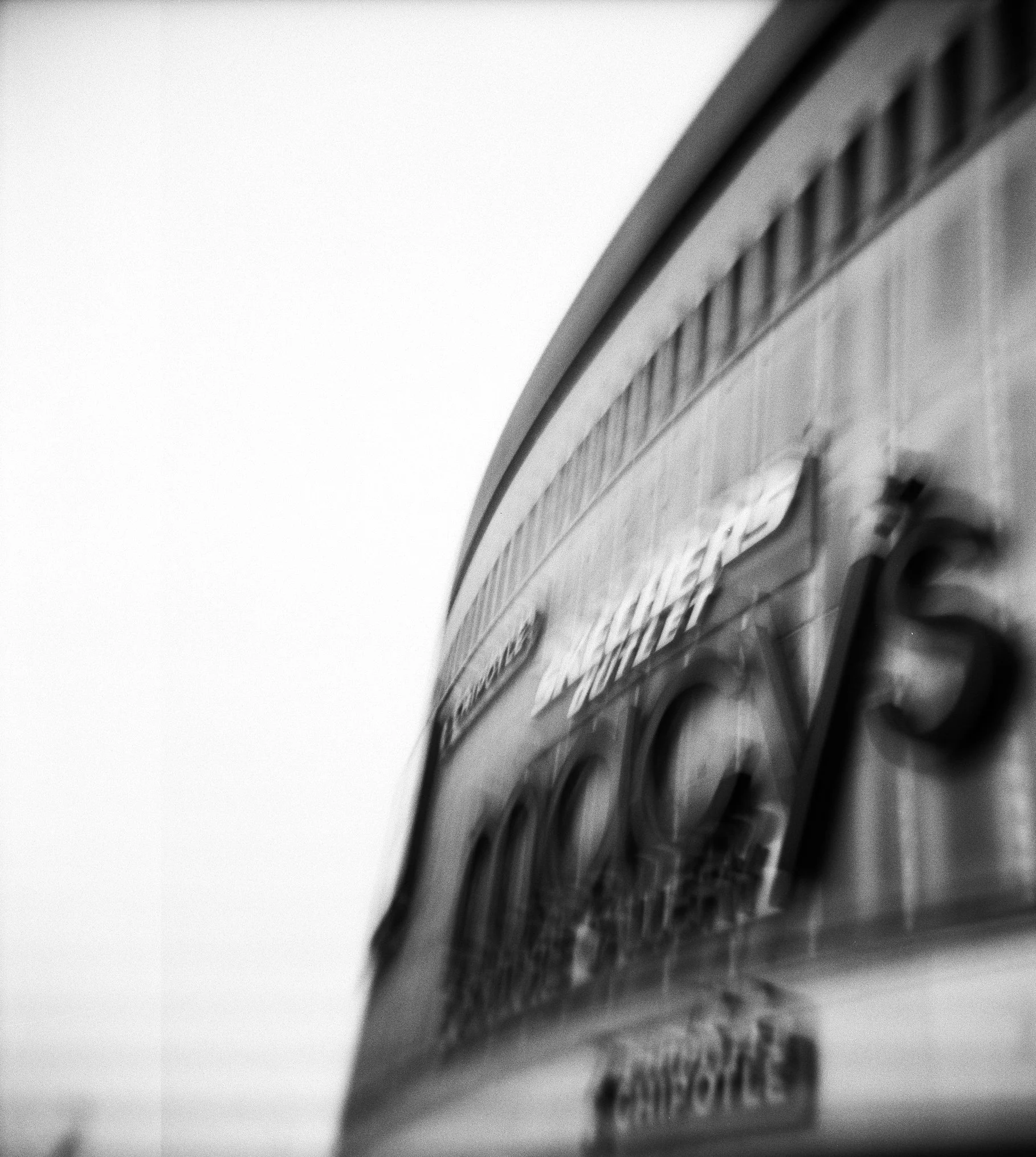 store signage that features prominently above the main entrance of the queens place mall