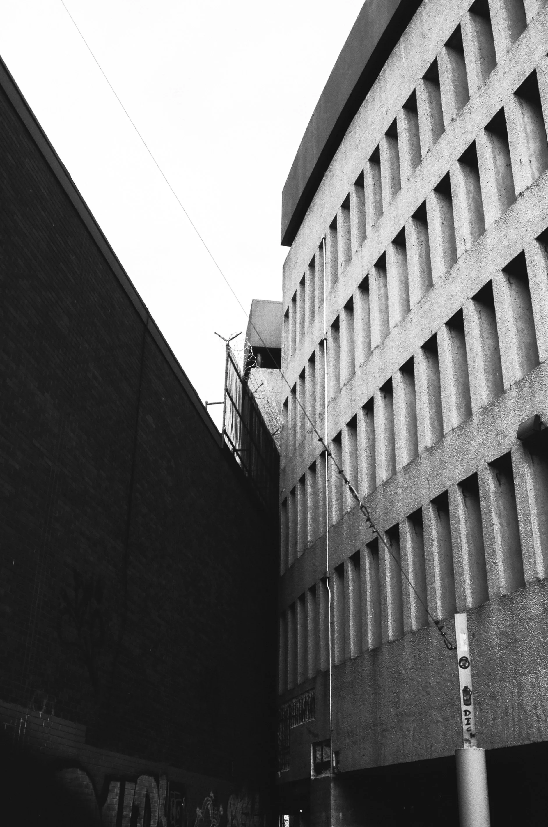 the notch that breaks the circular design of the queens place mall. it was created when macy's had to build around the sendek house