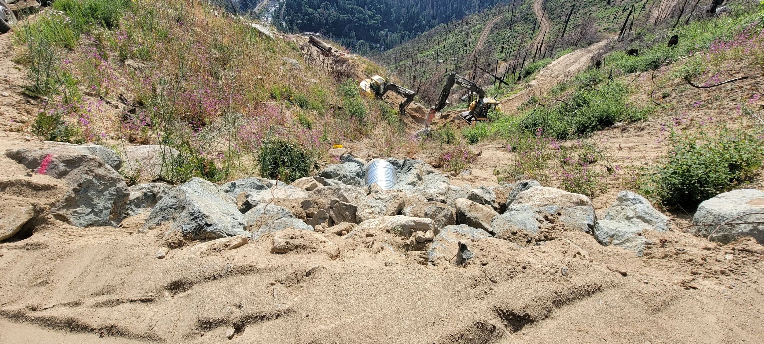 excavation site on hillside with machinery