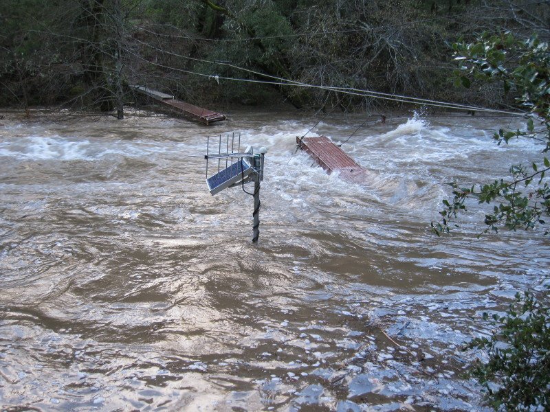 Flooded area with submerged bridges and floating debris