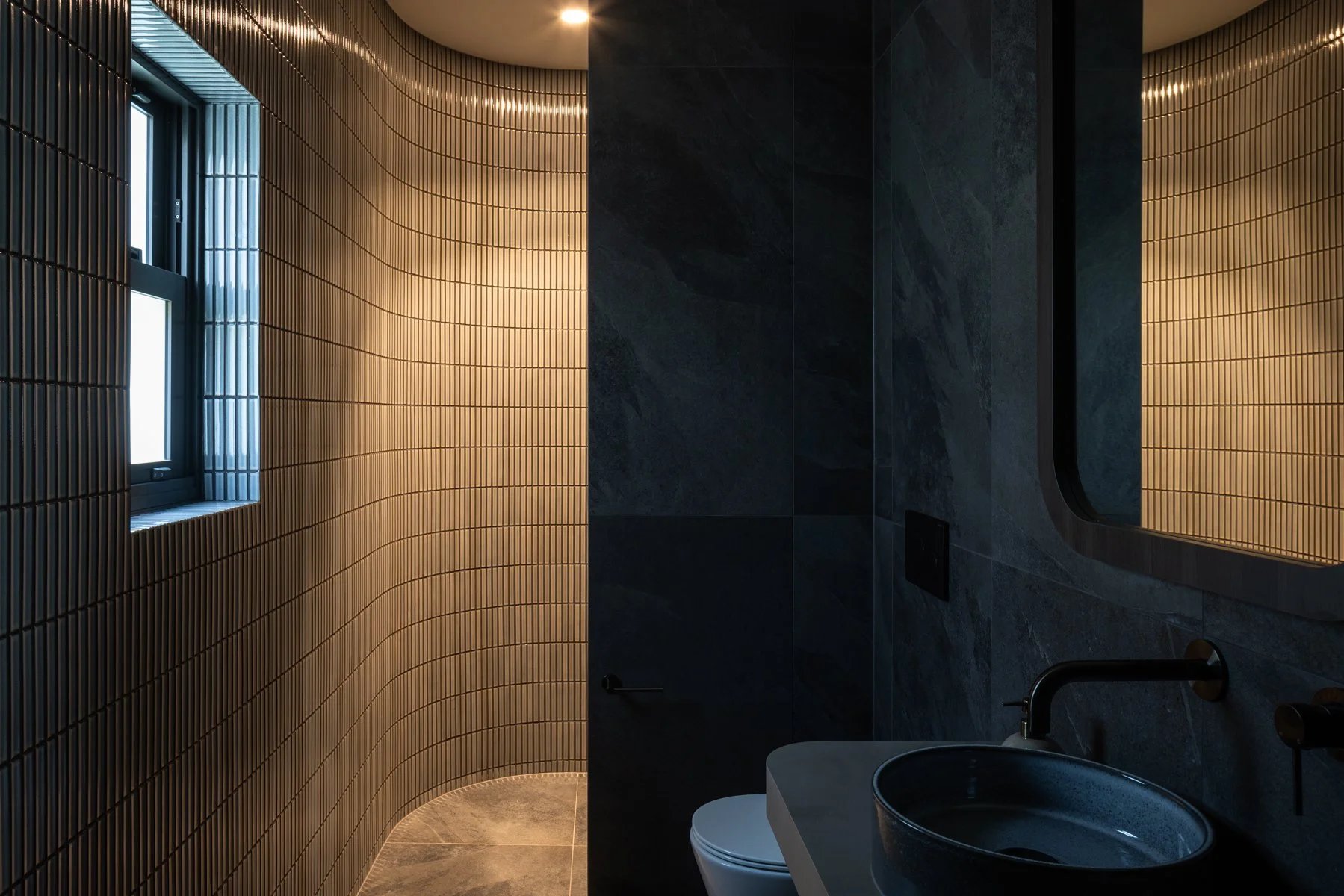 Hidden powder room.   This updated new powder room, complete with shower serves as a new ensuite for the neighbouring bedroom 