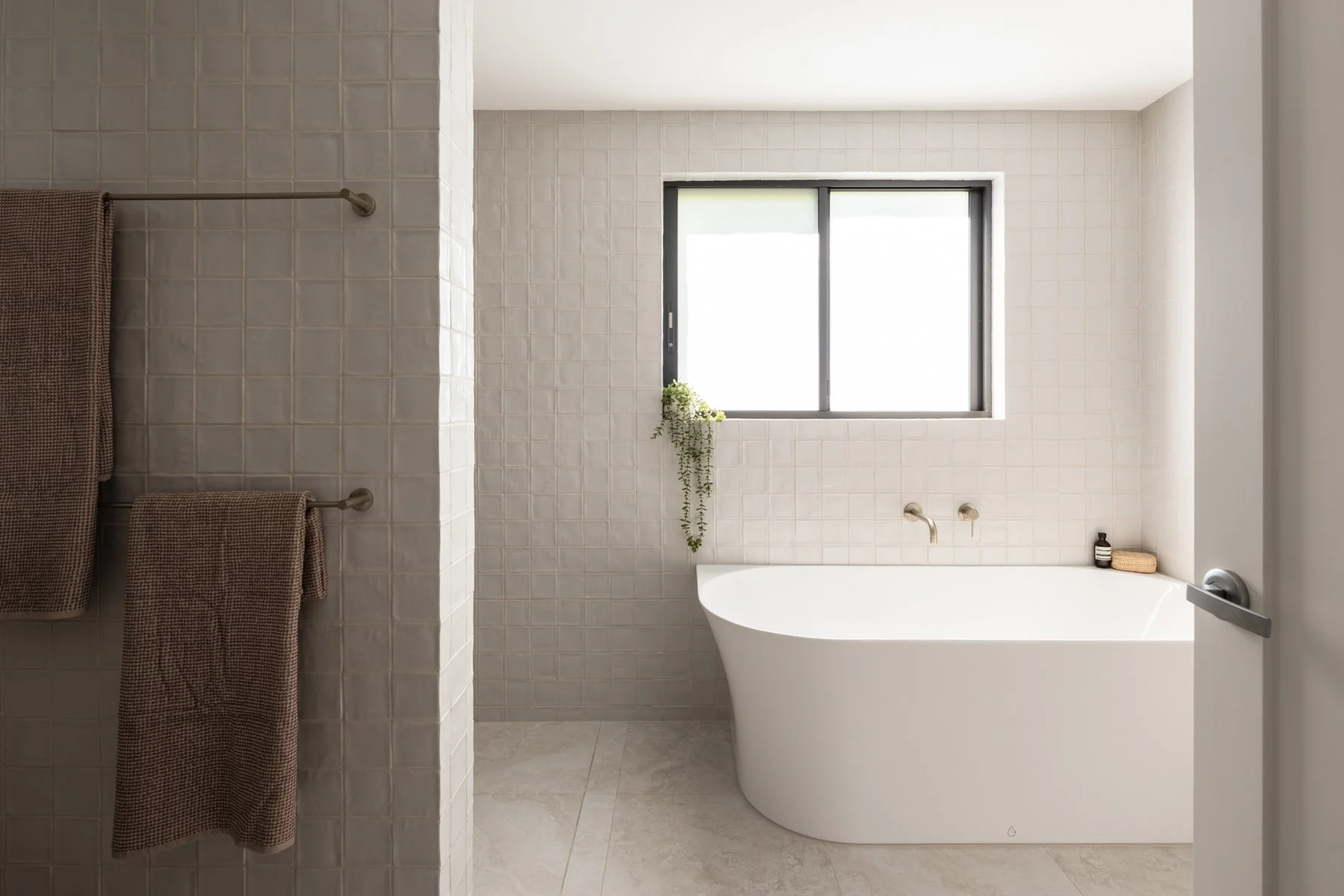 natural light and a neutral colour palette, a functional back to wall corner bath gives the illusion of a freestanding bath