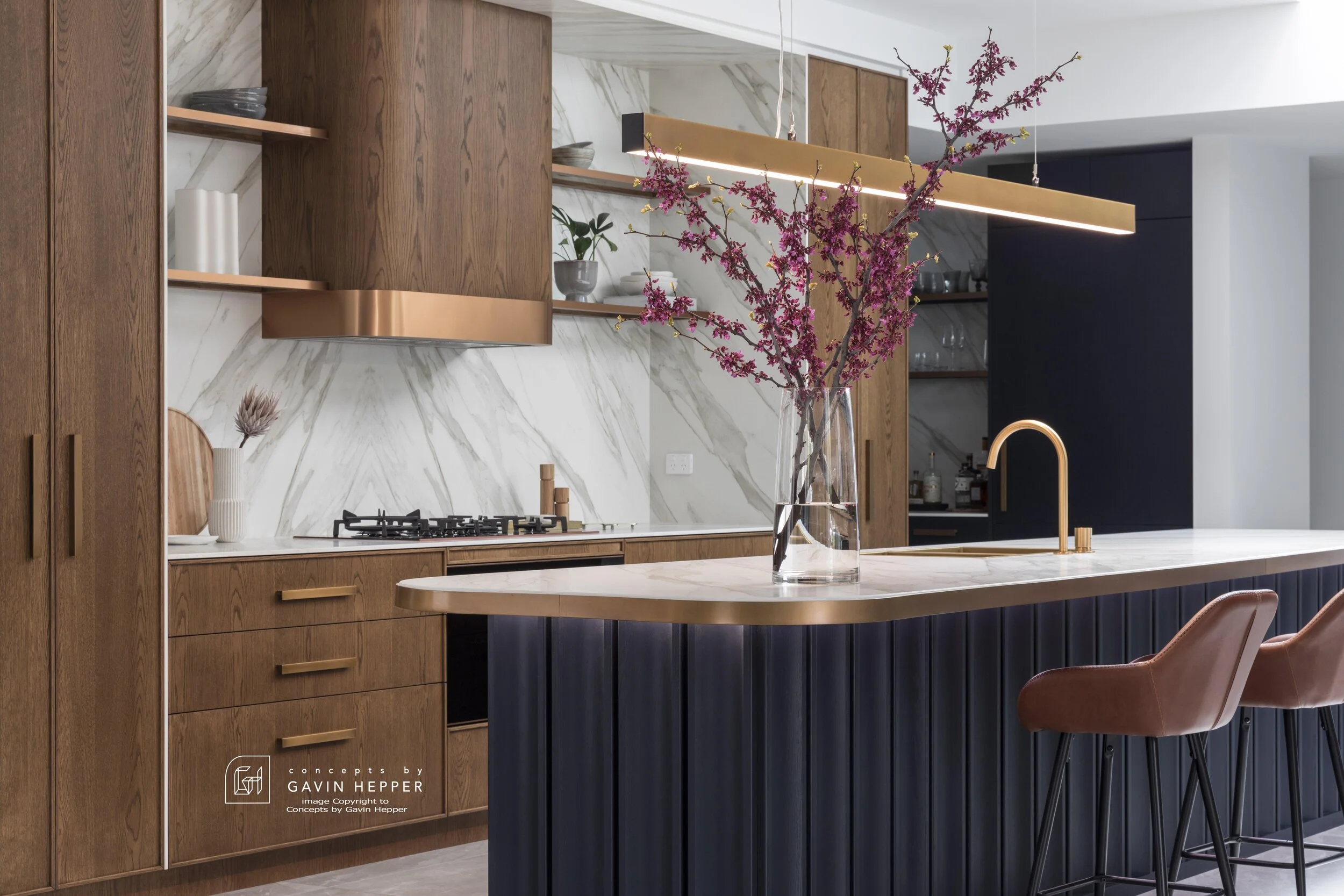 Farmers Doors Japanese stain in slimline panels, custom Oxford Blue oak slab and glowing bronze metallics highlight this kitchen renovation