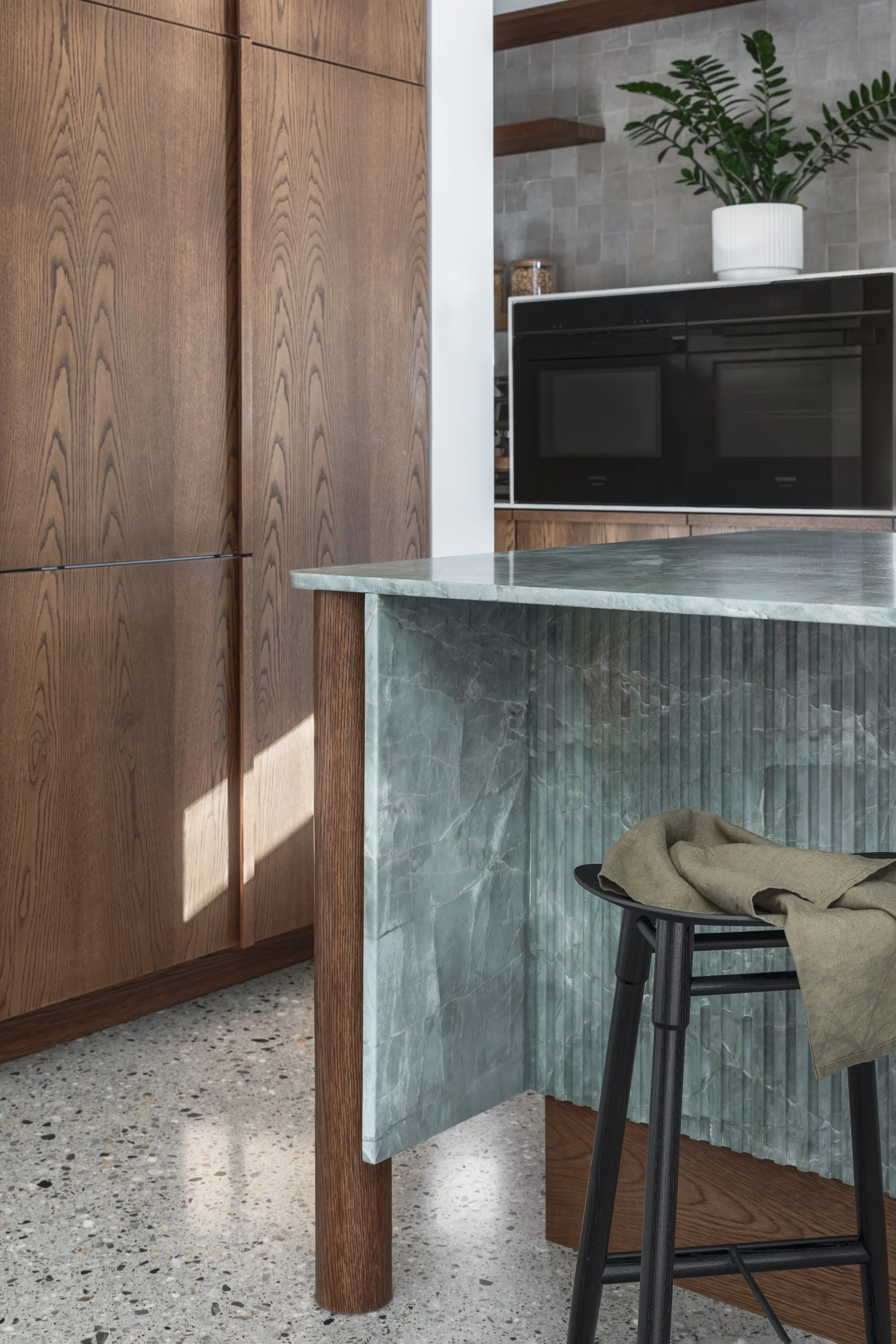 Emerald Green Quartzite kitchen island with teak joinery
