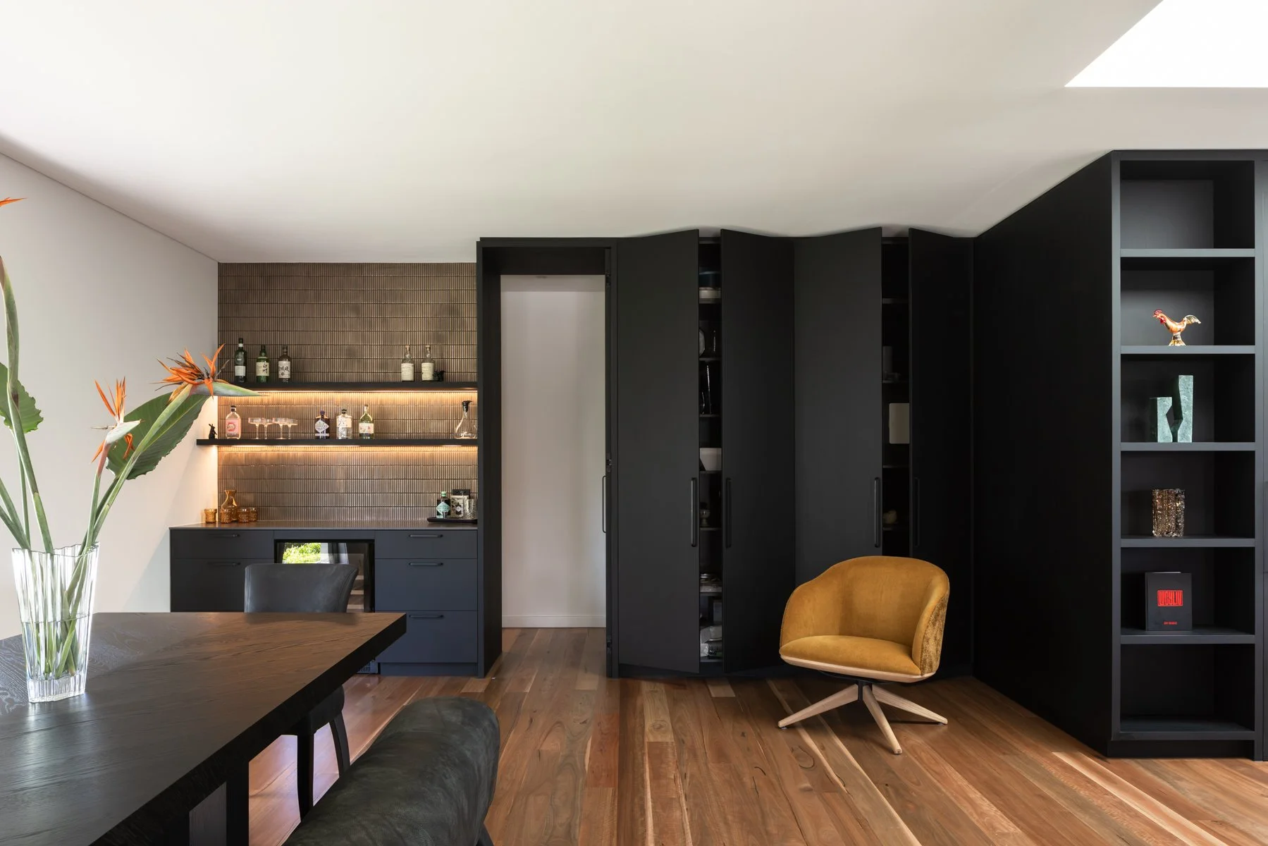 Hidden storage and secret panels conceal access to another wing in the house, feeling very James Bond