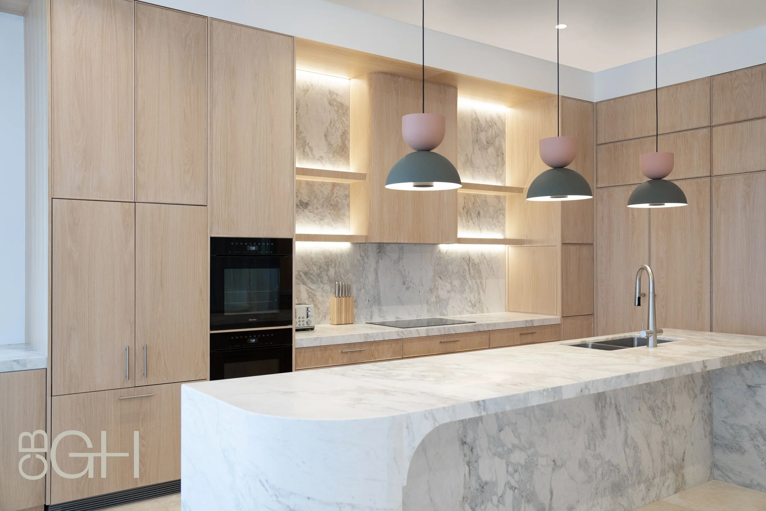 Soft curves lead the transition around this entertainers kitchen 