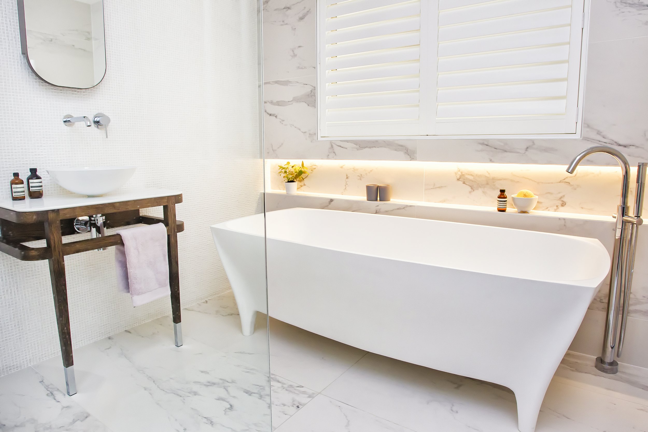 An elegant Zuster vanity celebrates the furniture like elements in this spa inspired bathroom