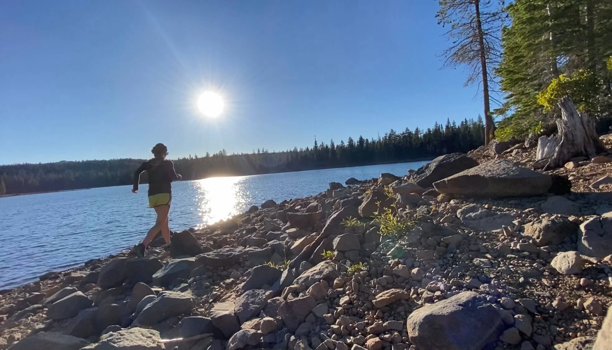 woman running along lake