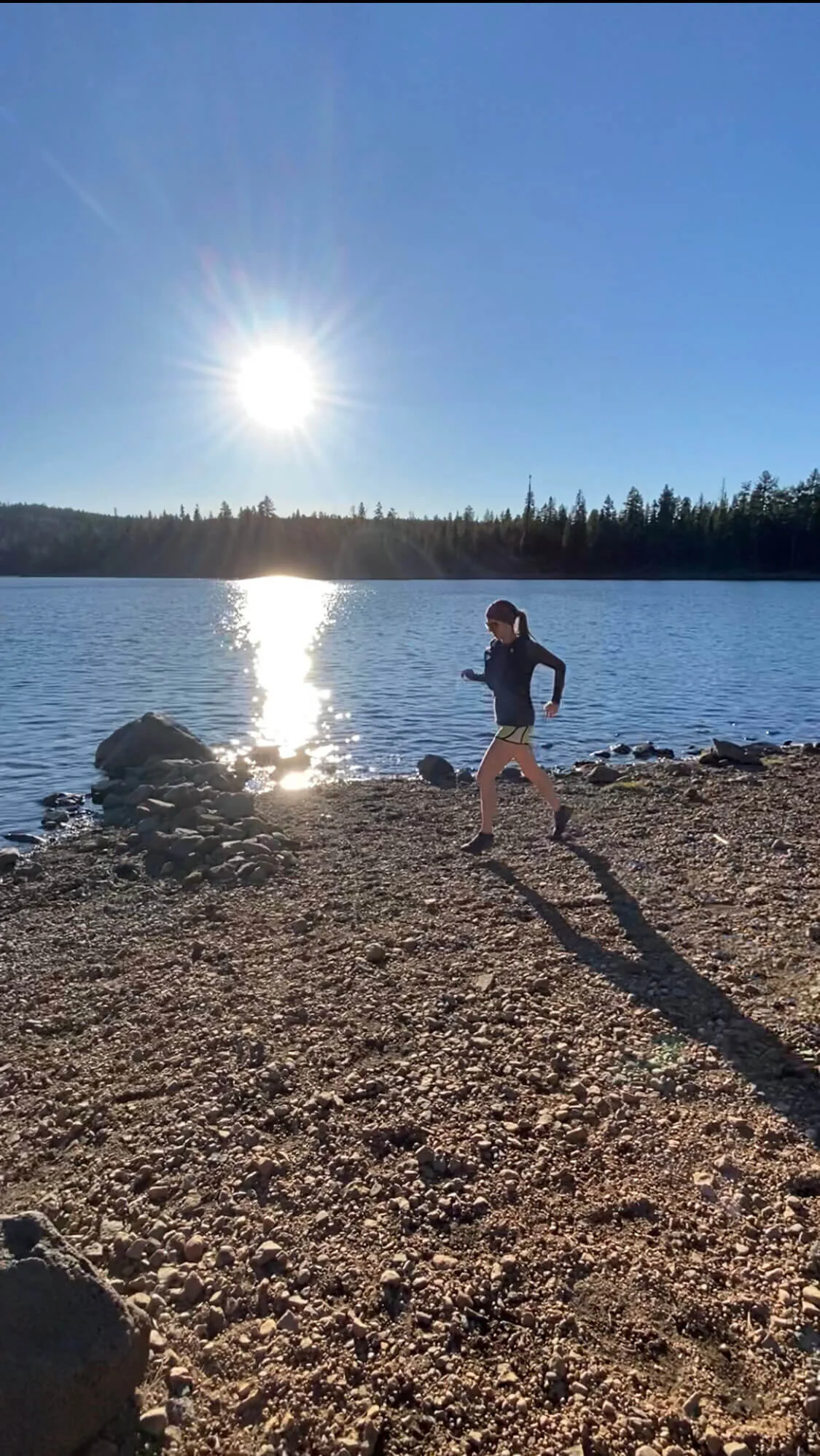 woman running along lake