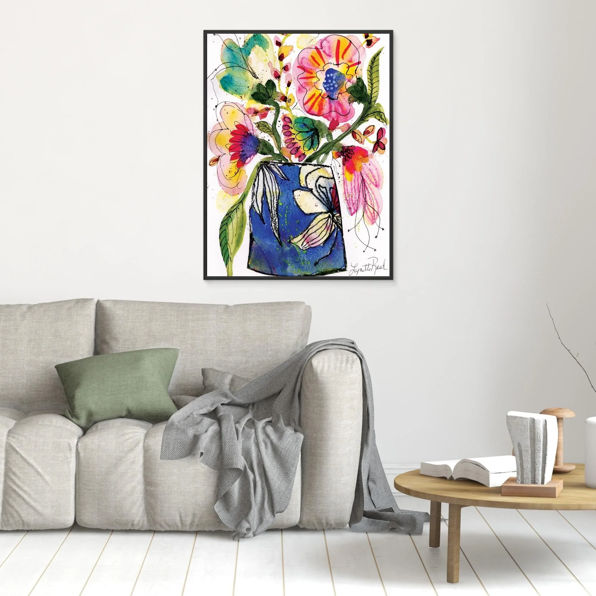 Blue Vase with Pink and Yellow Blooms canvas art print by Lynette Reed shown framed in a room setting