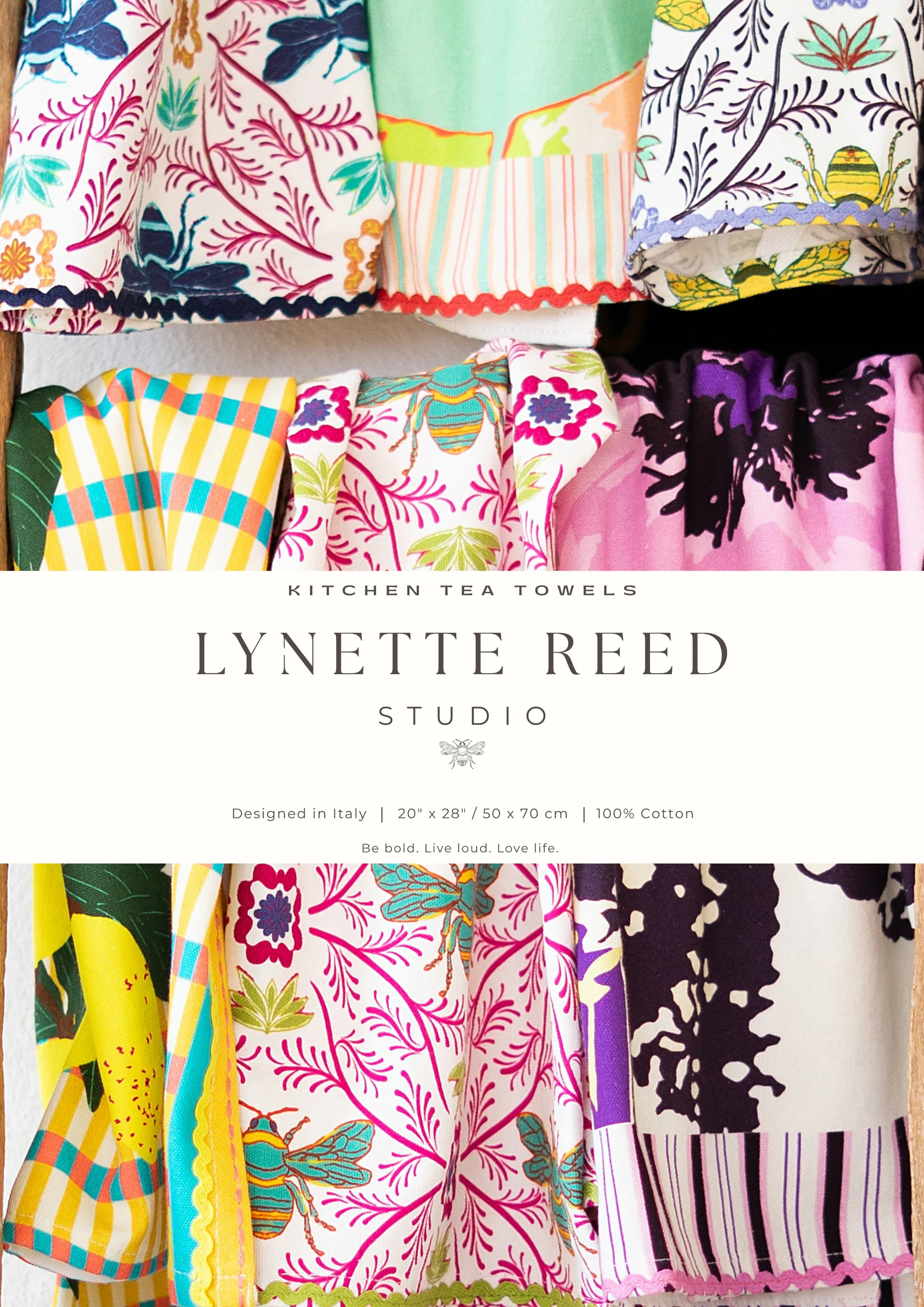 A close-up of colorful folded fabric with floral and intricate patterns laid on a wooden surface.