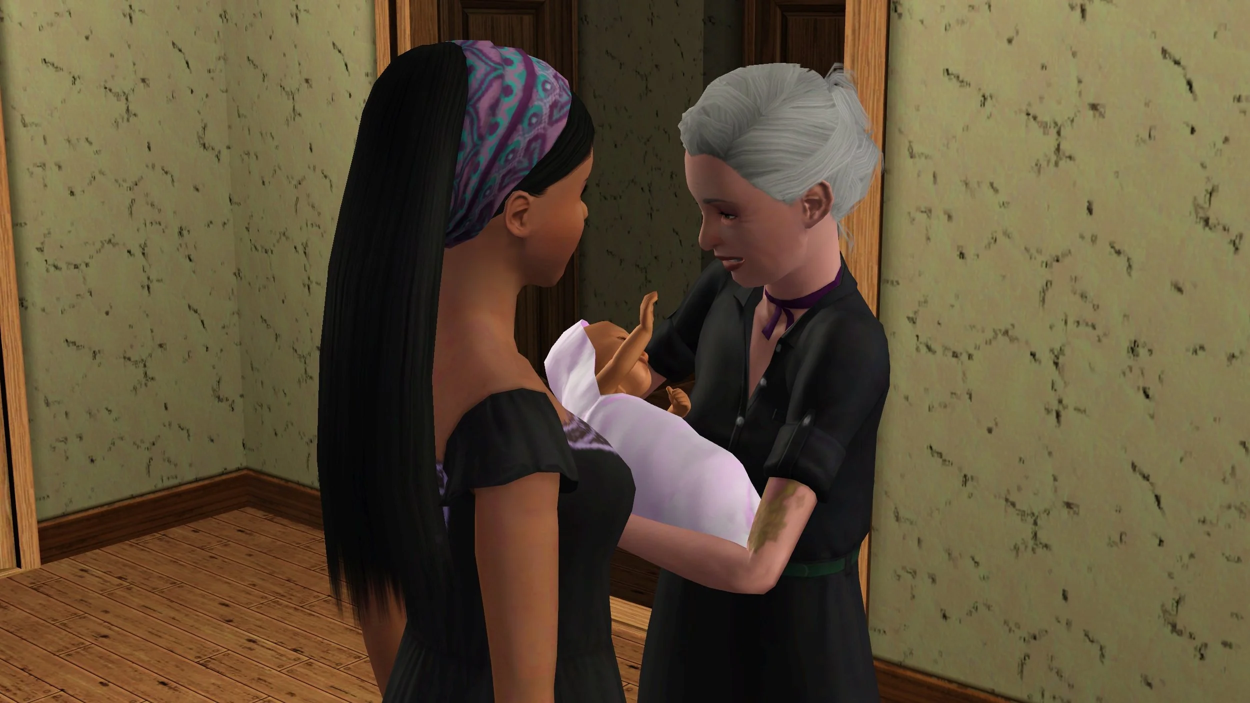 Bridget smiles and lowers baby Mara in preparation to pass her to Emery, standing only inches in front of her; Mara outstretches a hand towards her grandmother.