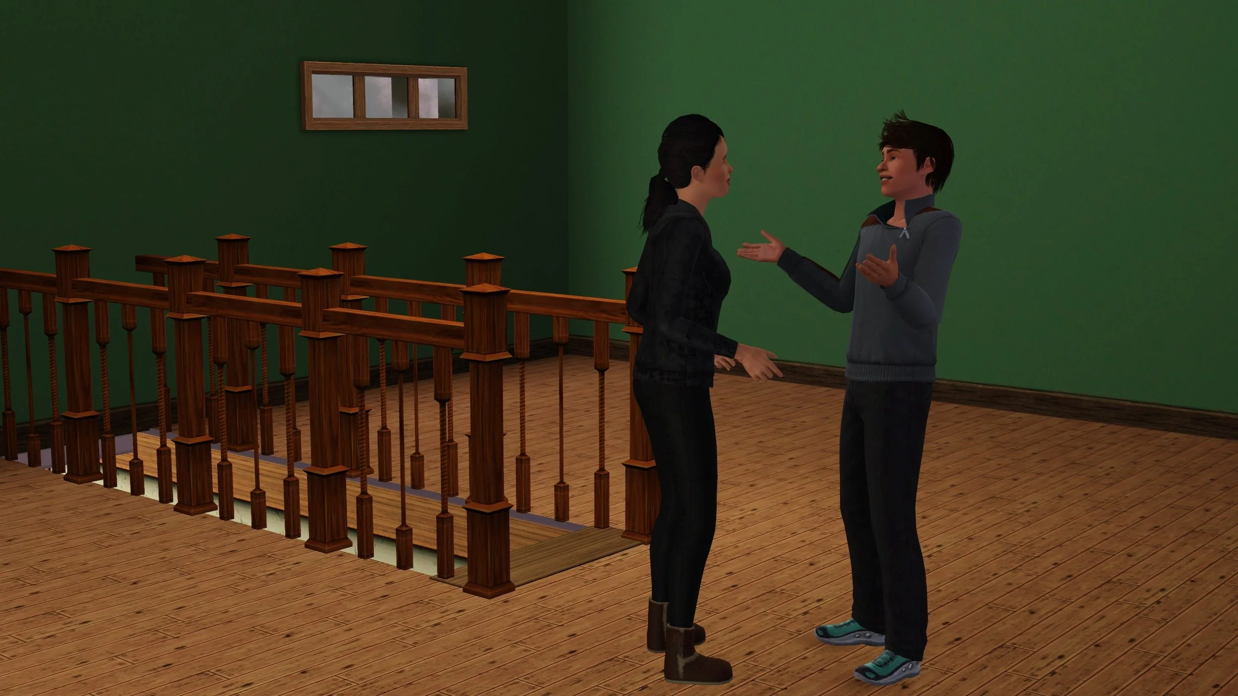 Matthew smiles and gestures with open arms, he and Dorothy facing each other, standing near a staircase with fence railings in an empty room with wood floors, painted green walls and a small window.