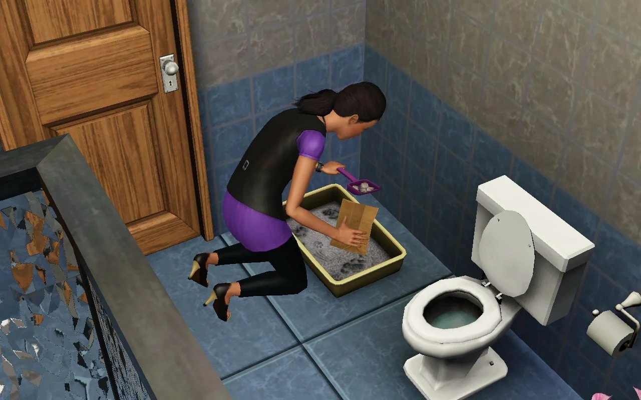 Young adult Sim Dorothy Button crouches on a bathroom floor next to a toilet, scooping cat poop out of a litter box into a paper bag.