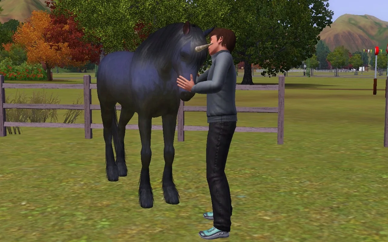 Matthew stands in front of Aasifa the unicorn with one hand on her snout and the other petting her neck.