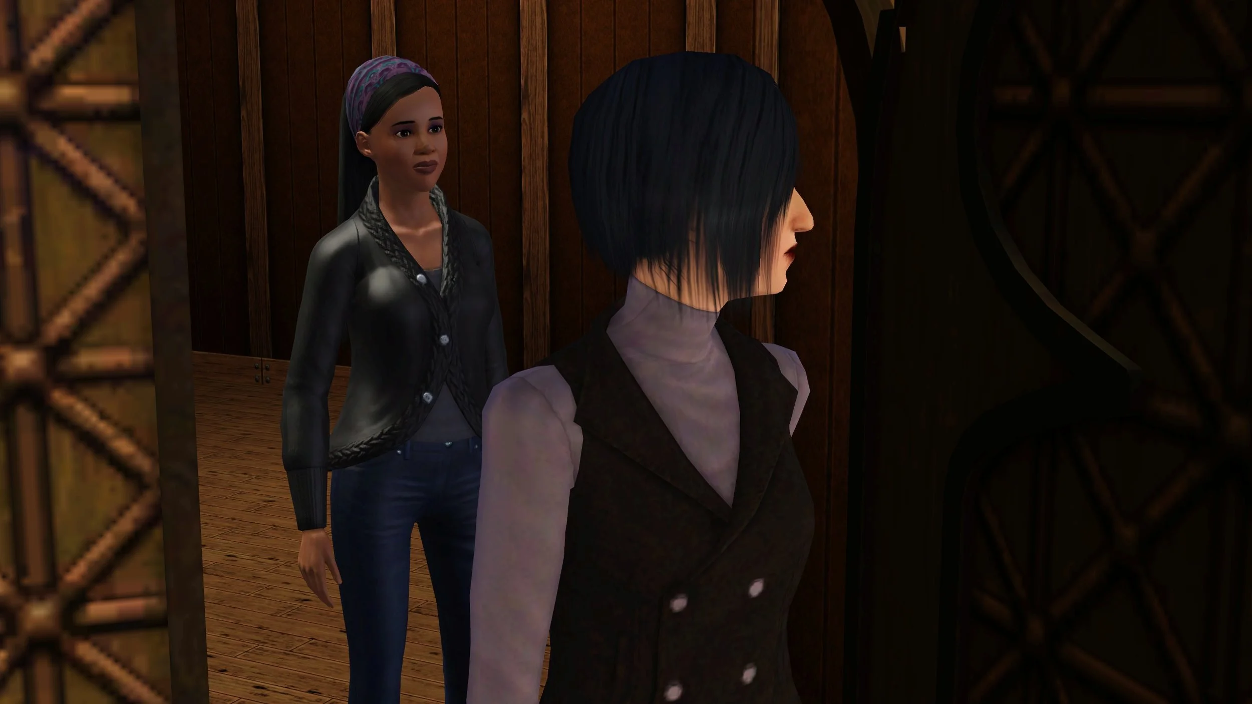 Colette glances back over her shoulder as she walks away from an open door. Emery stands on the other side of the doorway with an apprehensive expression, watching Colette leave.