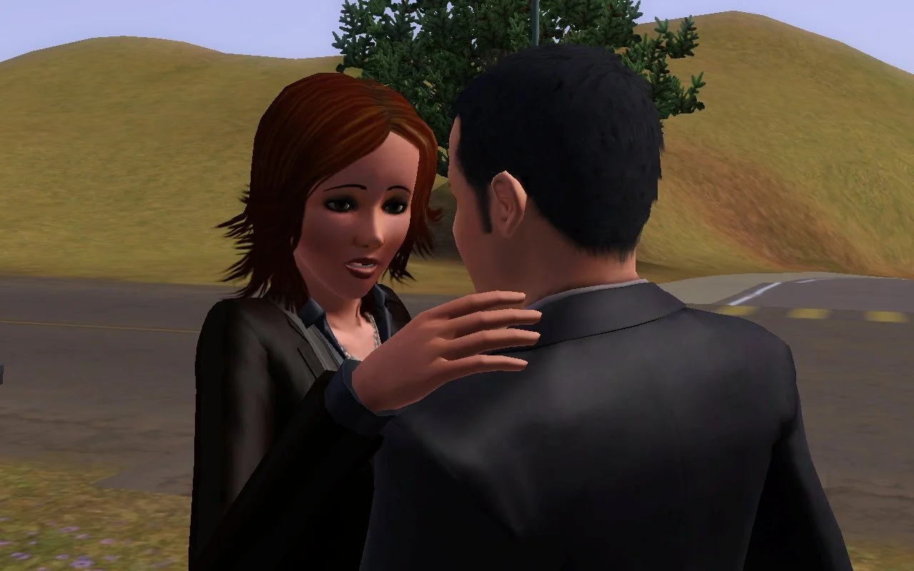 Alani, with a sympathetic expression, touches Mason's shoulder. She has thinly plucked eyebrows, dark eyeliner and other makeup in an early 2000s style. Her auburn, shoulder-length hair is a choppy, layered style. Mason's black hair is very short.