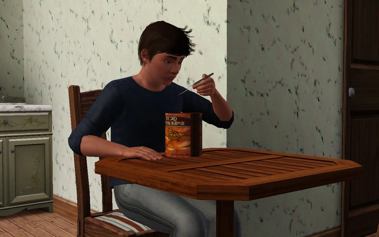 Matthew sitting alone at the dining table, eating ice cream directly from its container.