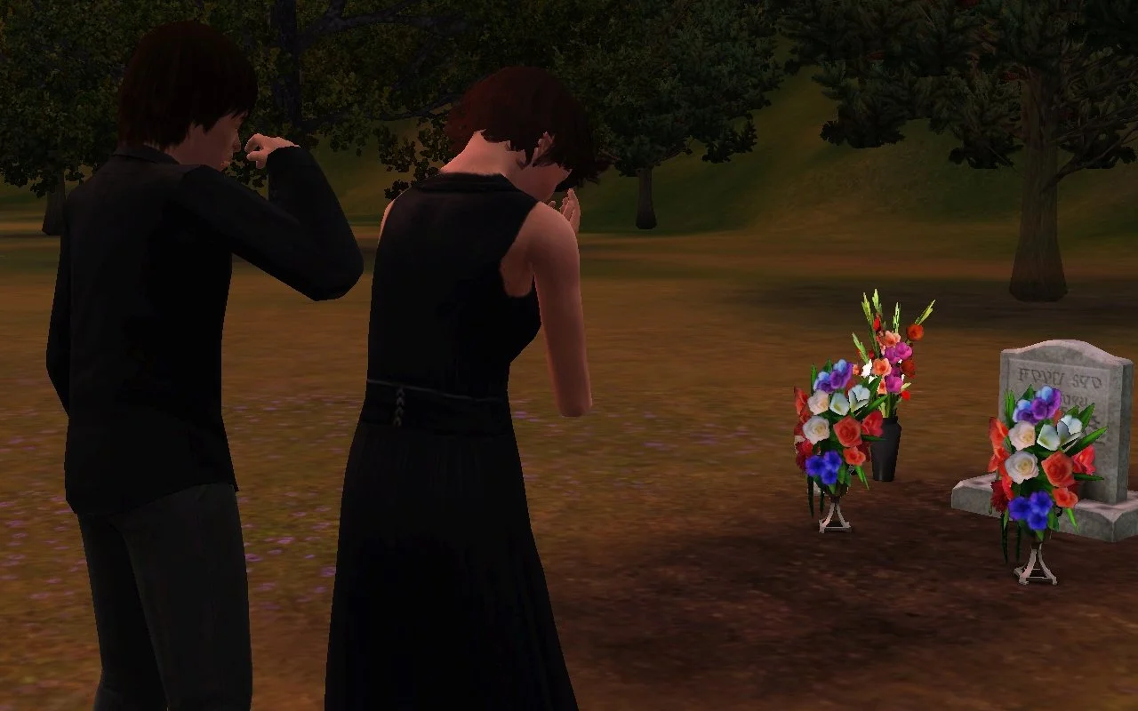 Chase wipes tears from his face, standing next to Aria weeping into her hands, both facing Altman's grave.