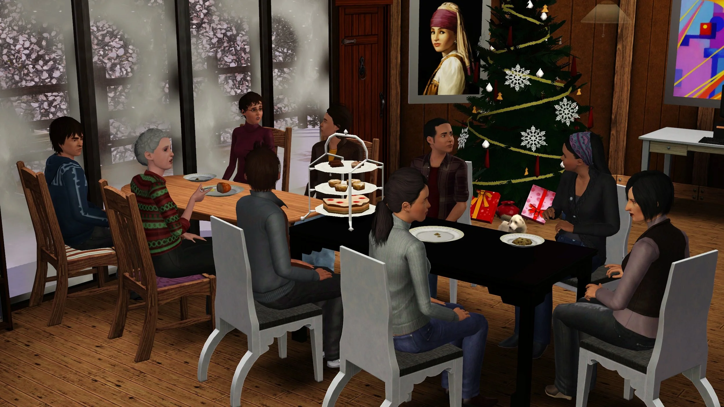 Sitting around 2 dining tables: Chase, Bridget, Matthew, Dorothy, Colette (head of table), Emery, Mason, Ryker, and Aria (across from Chase). Rusty and Christmas tree nearby. On tables: half loaf of bread, cookie, 3-tiered dessert tray, empty plates.