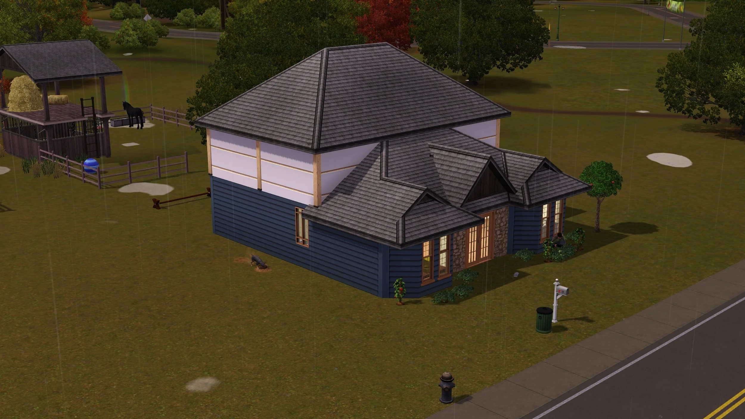 Button Ranch on a rainy day; a new 2nd storey has wood framing, air barrier sheets & a roof. Matthew works in the front garden; dog Petunia digs a hole at the side; unicorn Aasifa is at her paddock’s water trough with a small rainbow above her.