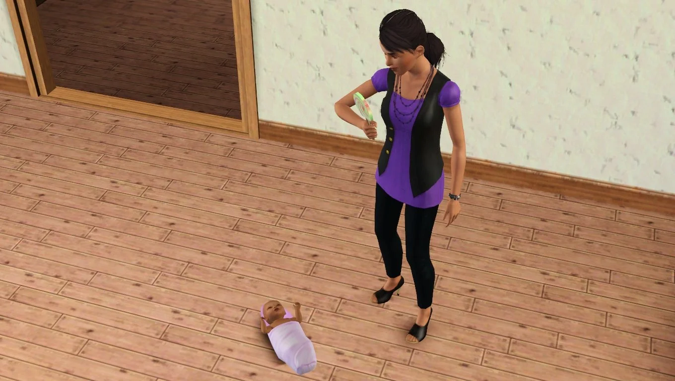 Baby Mara on the floor, hands raised, with Dorothy standing over her with a smug grin, holding a giant lollipop, and wearing her regular purple blouse, black vest, necklaces, leggings and open-toed heels.