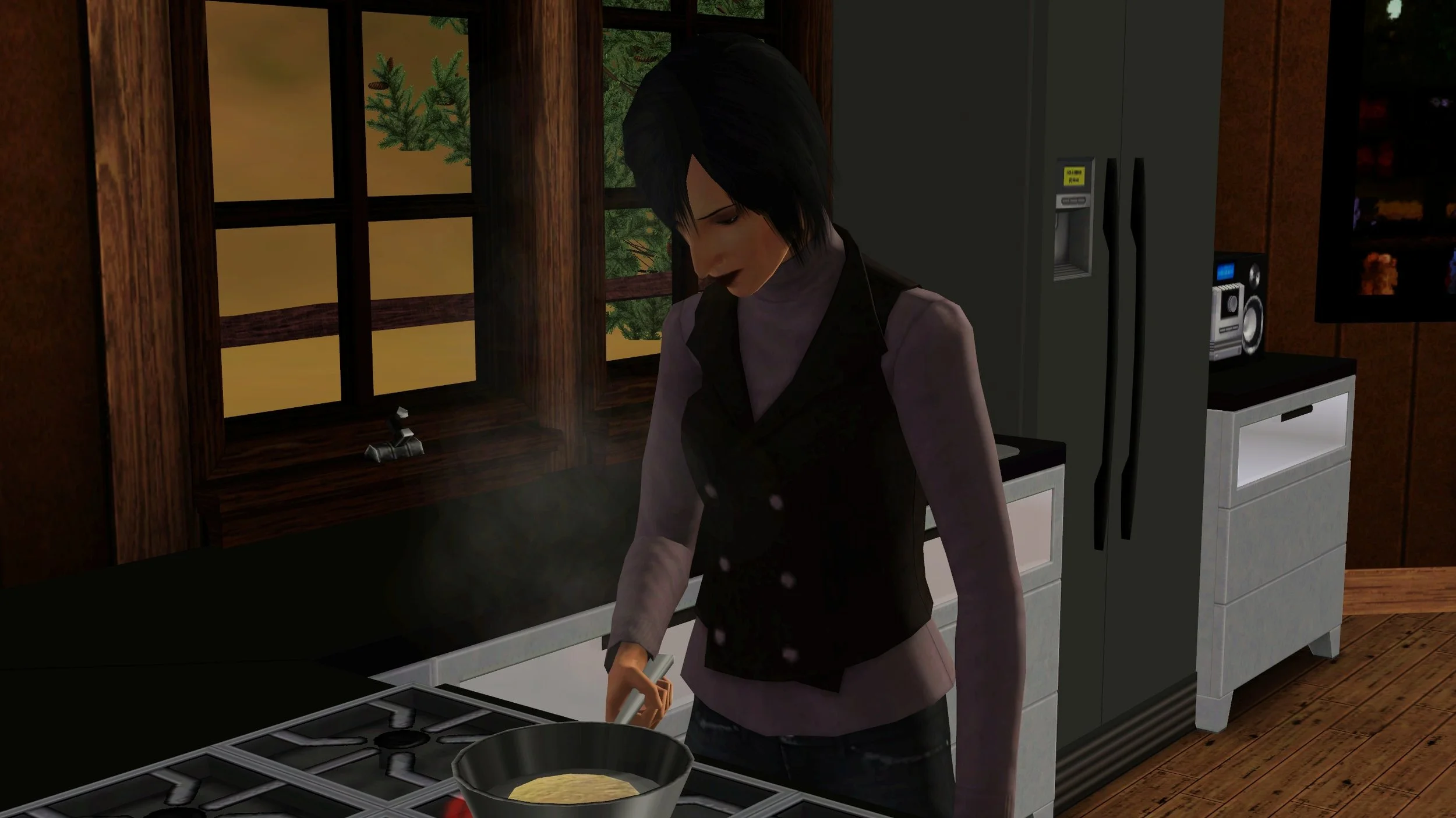 Colette focuses on a pancake in a frying pan, wearing a  sweater under a double-breasted vest. Behind her are wood walls and windows, stainless steel fridge, black countertops and modern base cabinets with frosted glass and white slab drawer-fronts.