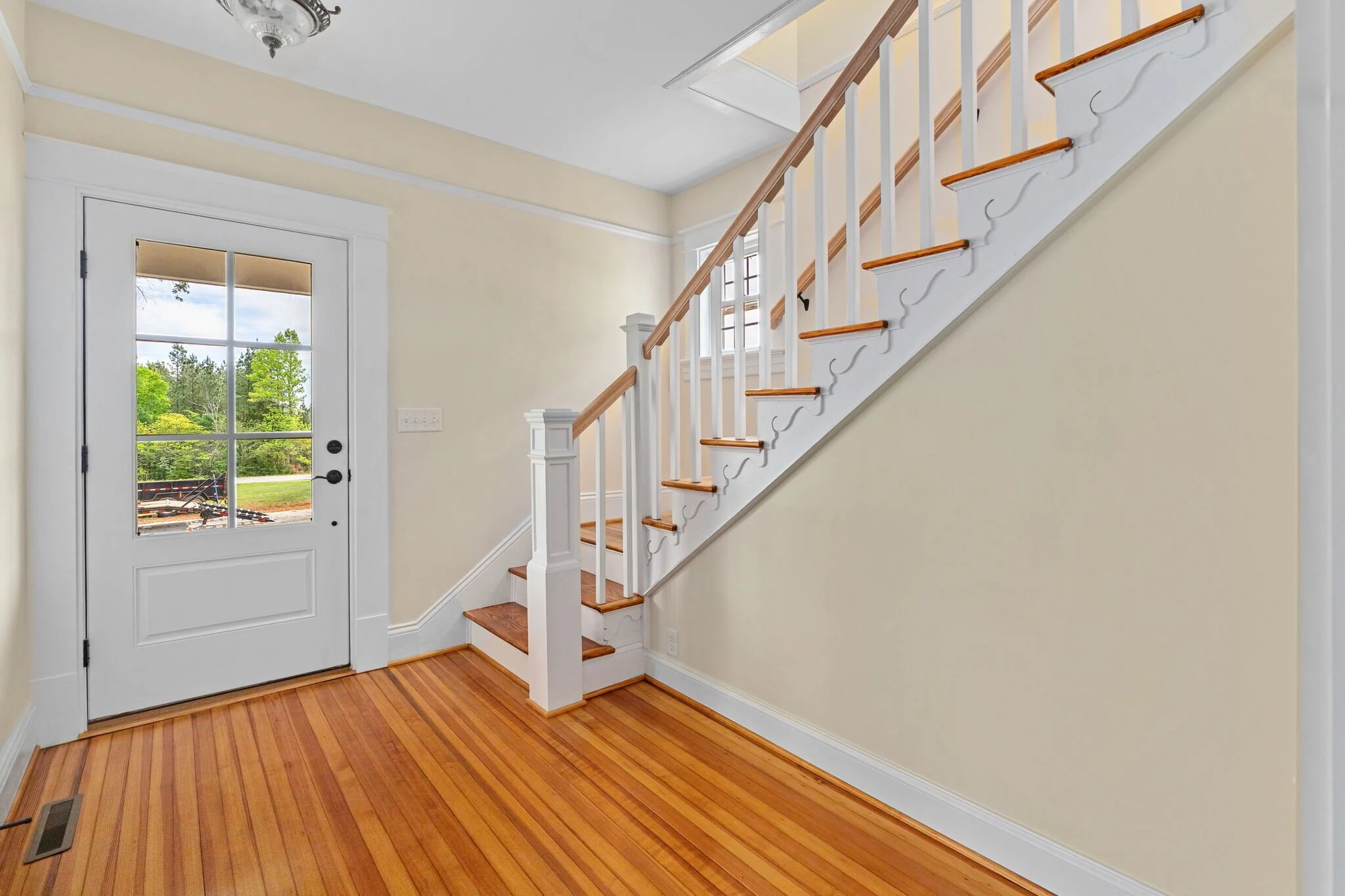 The farmhouse staircase got a fresh, elevated update. We removed the existing carpet to install hardwood treads with crisp white risers, then refinished the handrails and painted the newel posts for a clean, timeless look.

A favorite element is the 