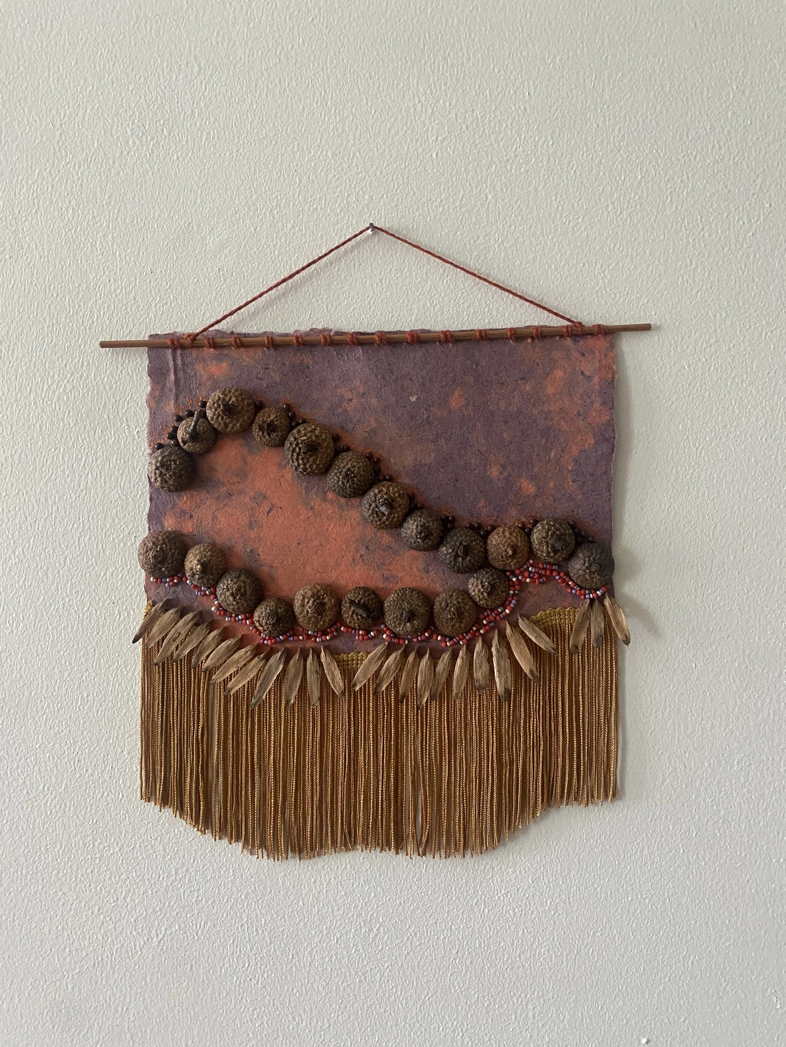 Veneration of Acorns 3 | handmade paper, acorn caps, tulip poplar seeds, decorative elements | 2025