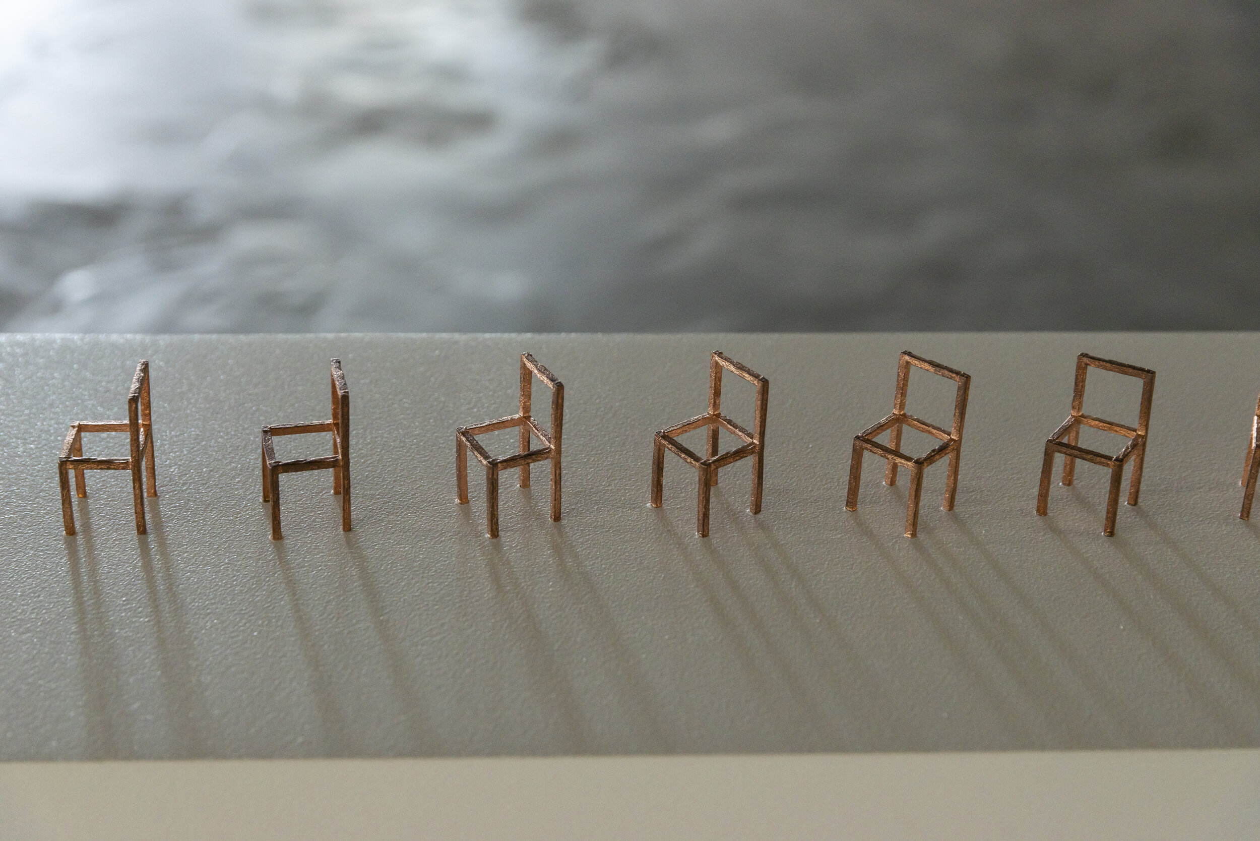   30 Bronze Chairs Facing Different Directions, and a Chair   Photo: Simon Strong  