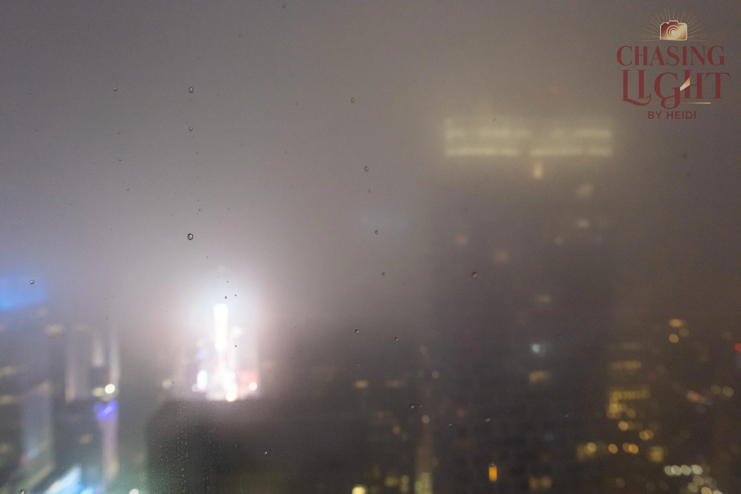 Looking out a window on a rainy night in NYC