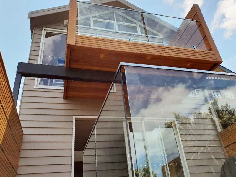 Beautiful balcony renovation. Glass paneling looks very sophisticated in this home.