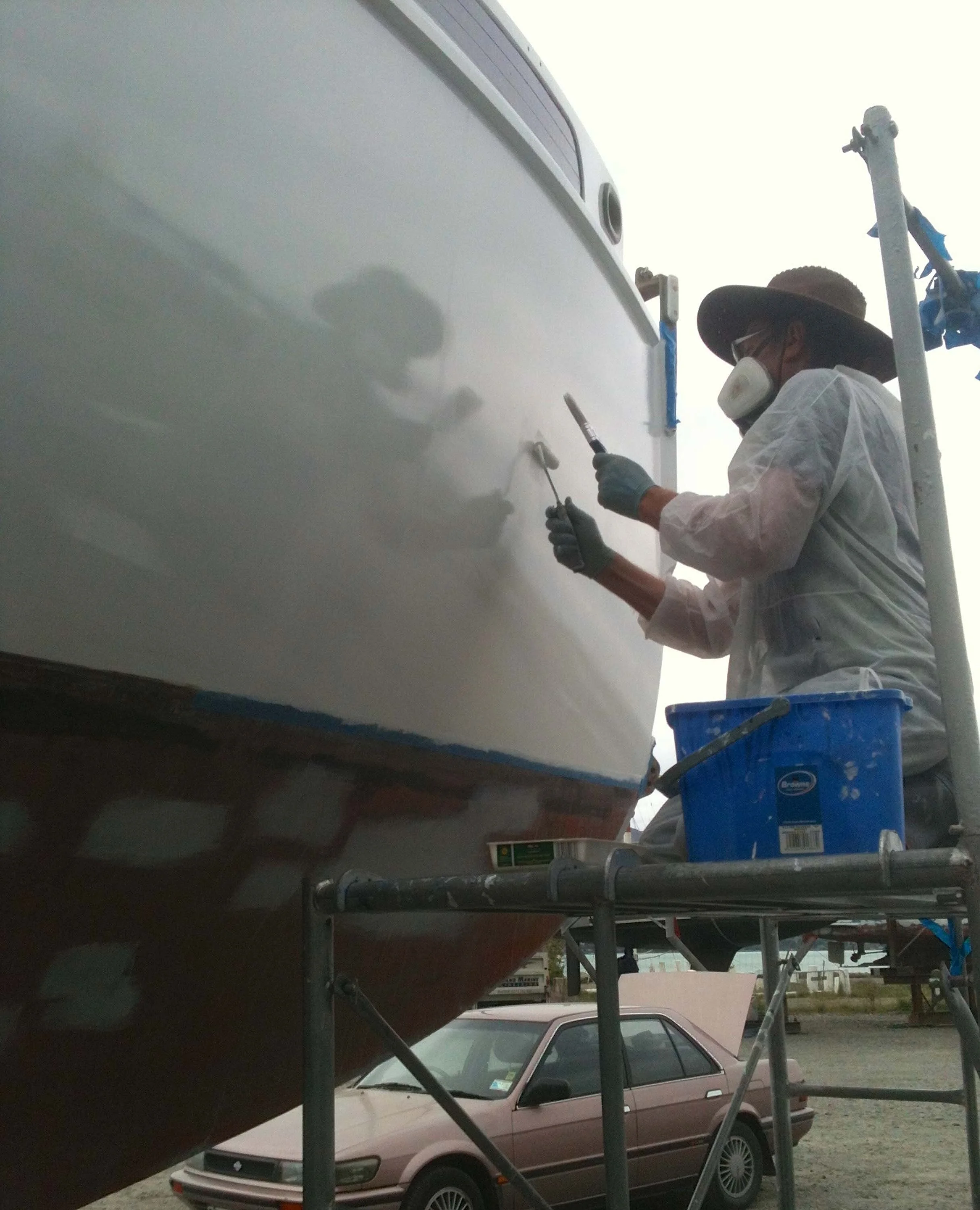 Vic painting an image of himself with roller and brush.jpg