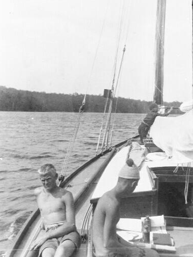 Crew on the port side deck of yacht UTIEKAH II just off shore.png