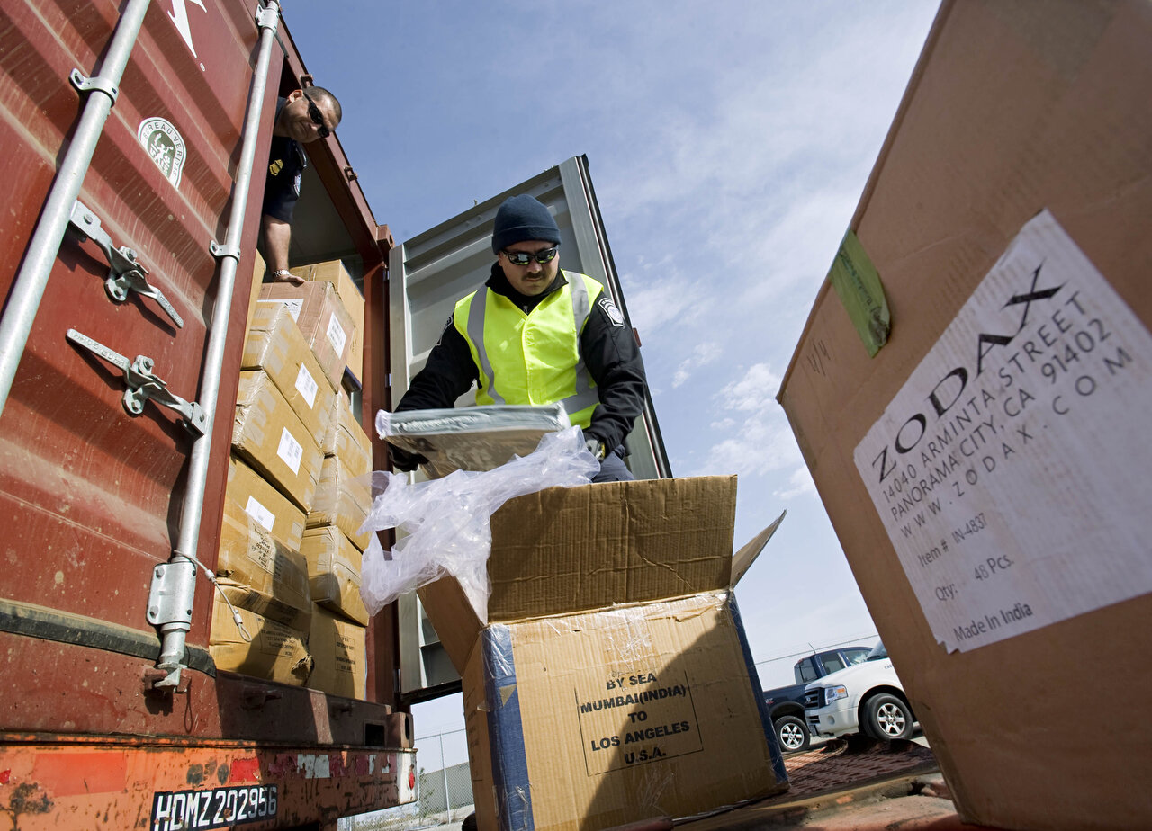 LONG BEACH, CA – Officers with United States Customs and Border Protection inspect the contents of a container that triggered a radiation warning on its way away from the Port of Long Beach on December 1, 2012. The container's manifest suggested that