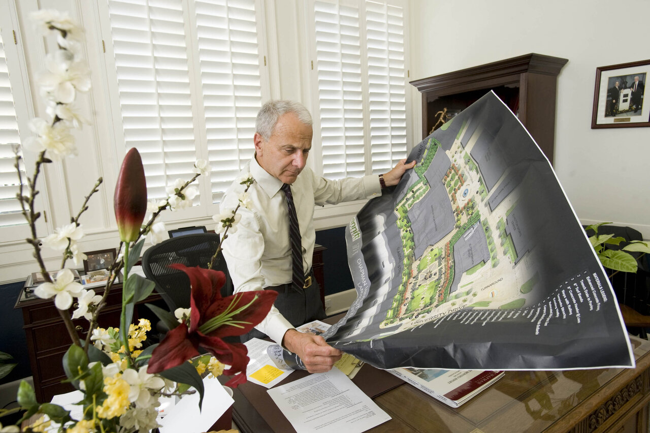 ORANGE, CA – Jim Doti, president of Chapman University, reviews plans for a multi-million dollar Center for the Arts project in his office on August 30, 2012. The university plans to break ground on the project next week. Doti says that his close tie