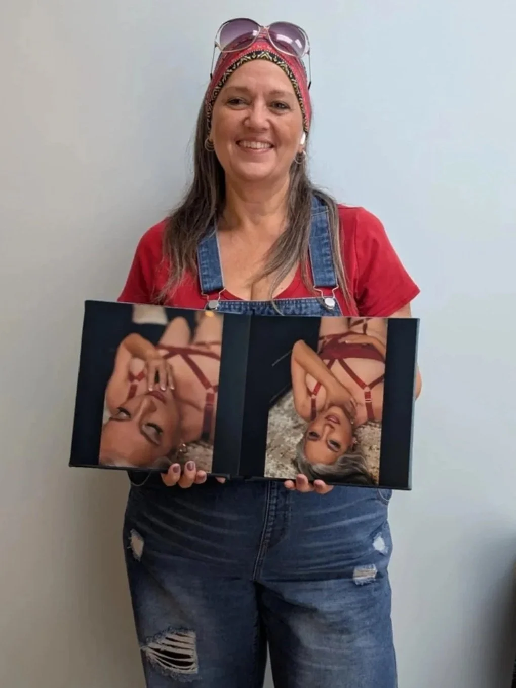 woman overalls holding boudoir album